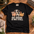 Schwarzes Herren-Shirt mit Kuh, Schwein, Huhn und Schriftzug Mei Bühne is mei Stall