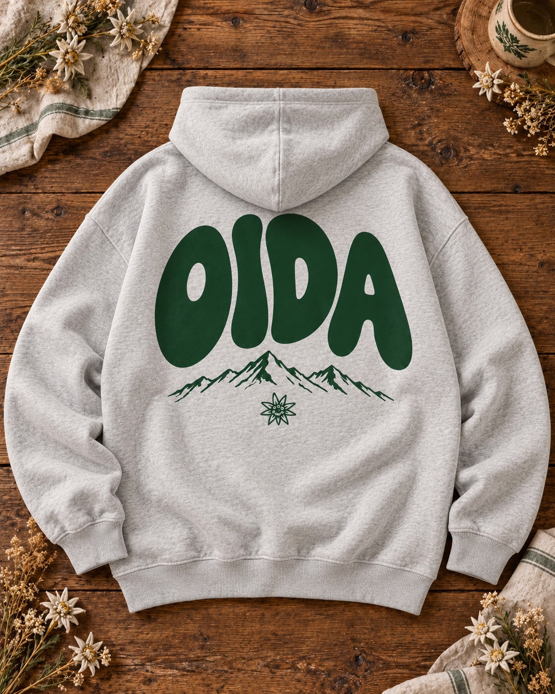 OIDA Oversize-Hoodie in Grau meliert, Rückenansicht auf Holztisch